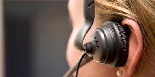Woman in call centre wearing ear phone device for calling